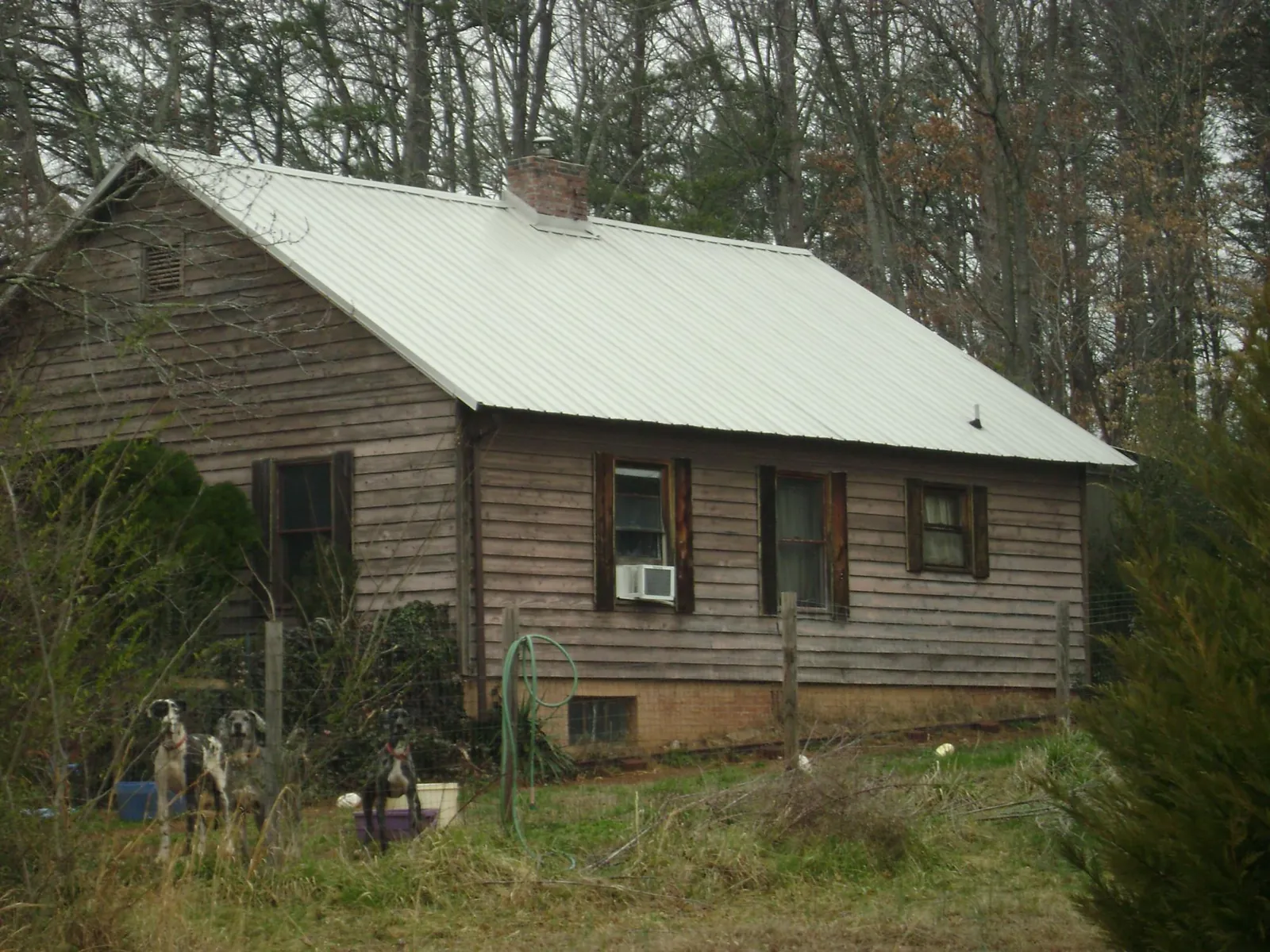 White metal roof on an old wood sided farmhouse, from a Asphalt Shingle Roof Repair job in Bishopville